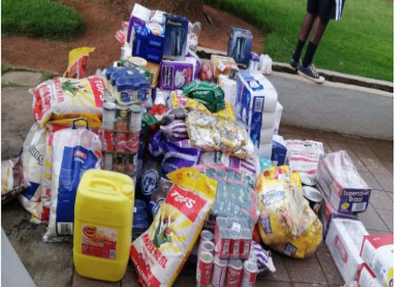 Food parcels and household goods stacked for distribution