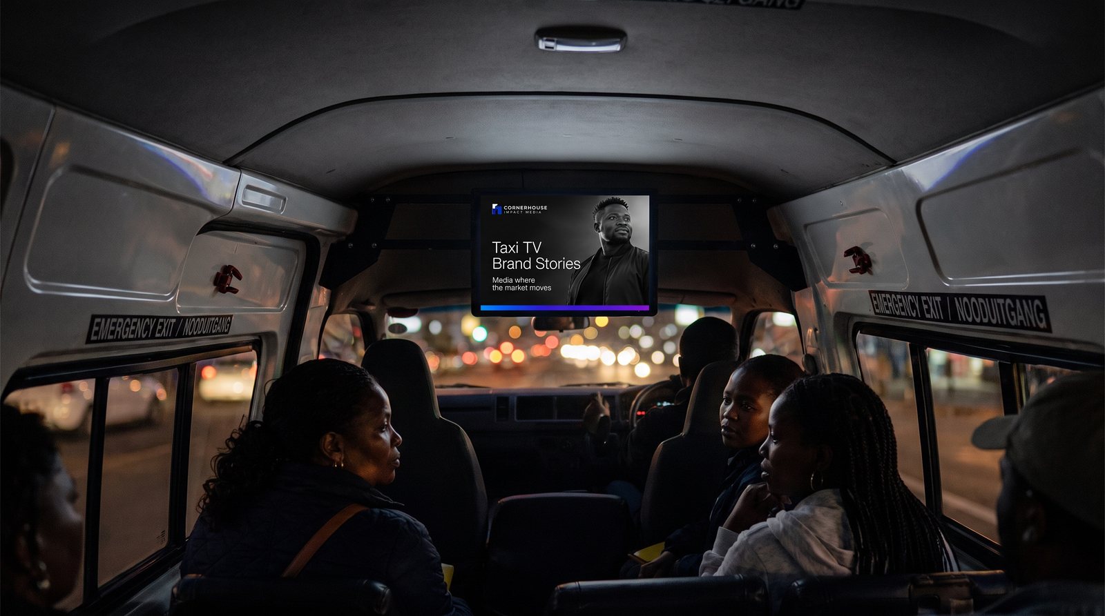 Taxi TV screen glowing inside a minibus taxi on the evening commute