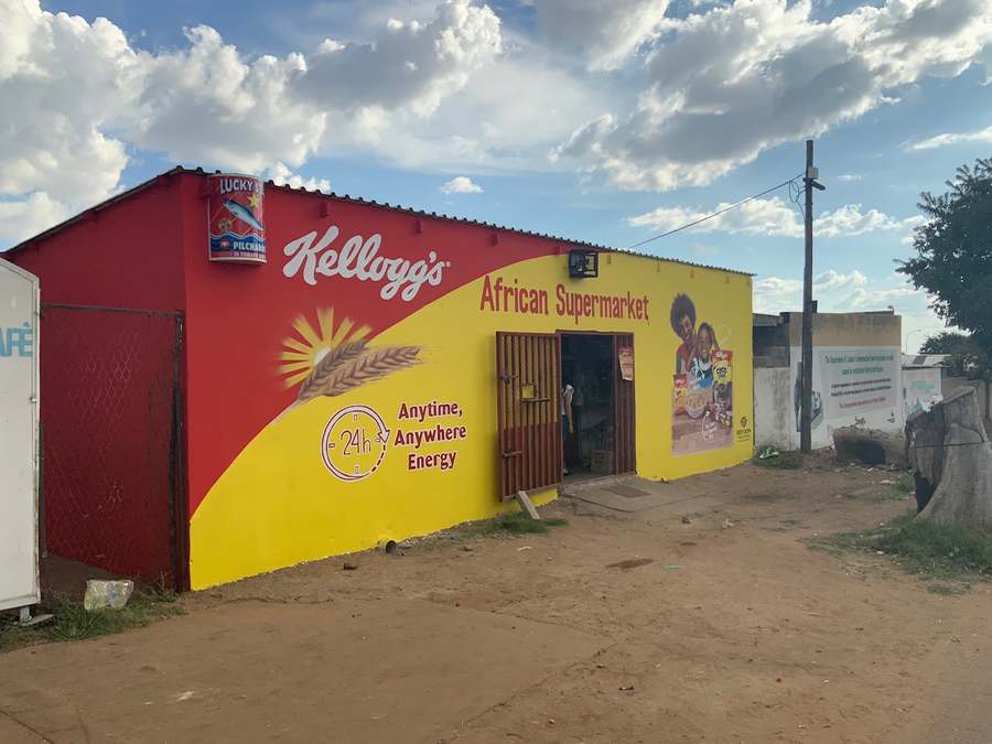 Kellogg's African Supermarket exterior in red and yellow with branded shop name