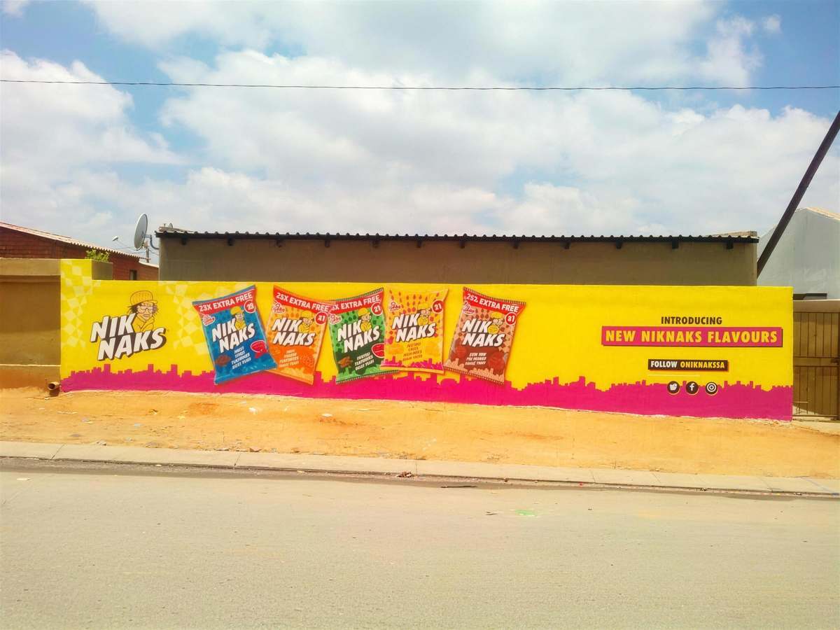 Front-on NikNaks flavour wall with magenta skyline silhouette