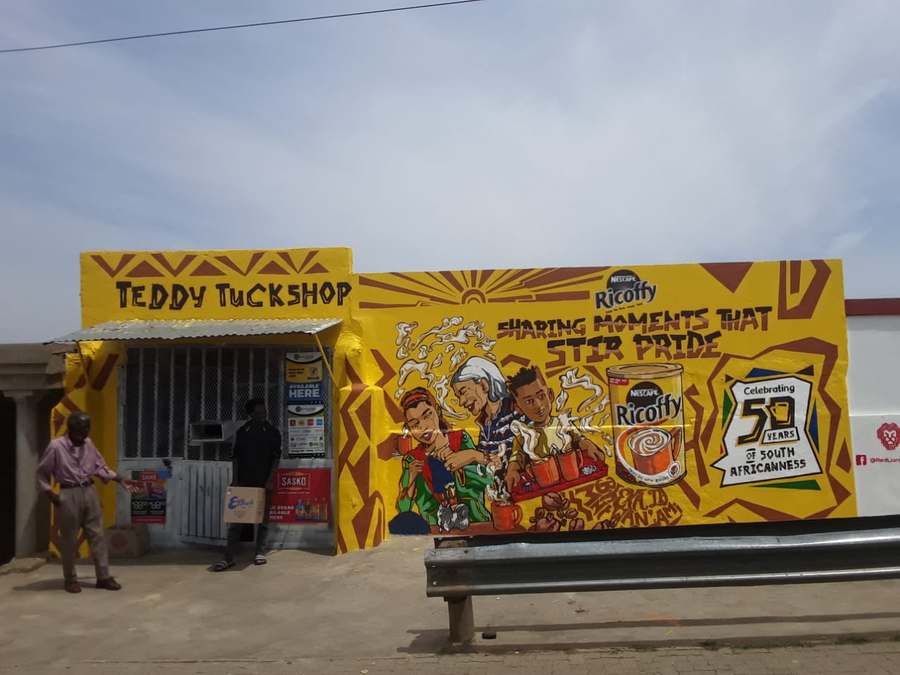 Teddy Tuckshop corner store painted in a yellow Ricoffy heritage mural