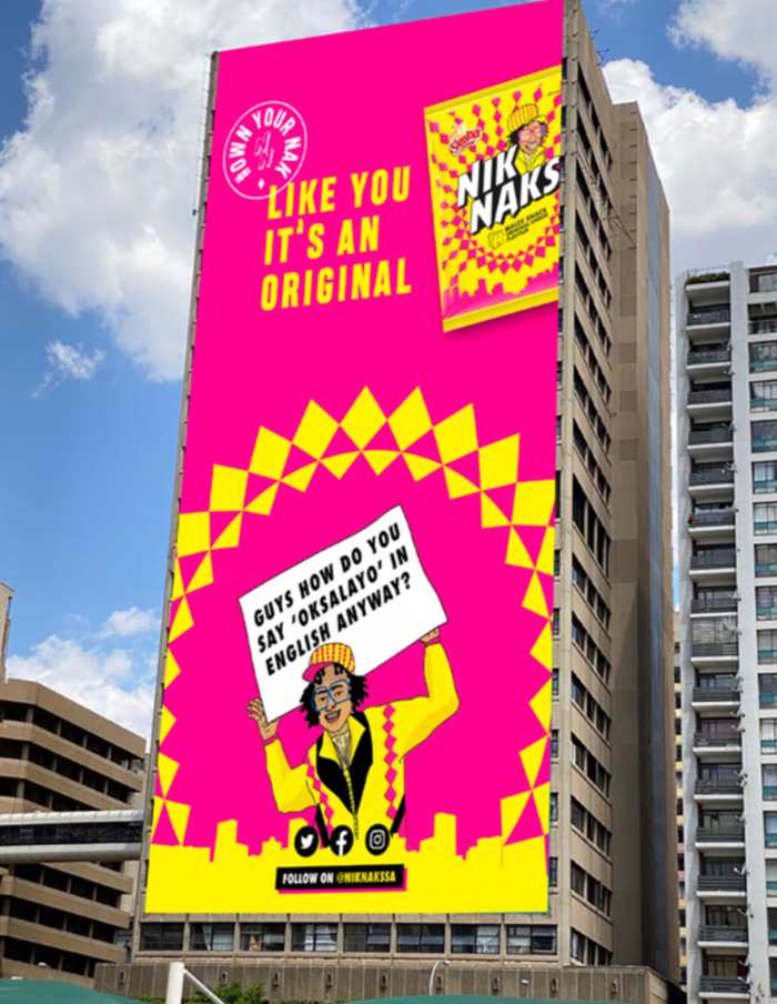 High-rise brand tower wrapped in bright campaign creative